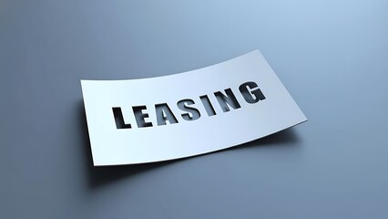 White paper with cut-out word LEASING floats above a cool grey background, suggesting finance and rental agreements.