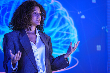 Portrait of successful business woman standing in front of digital background. Diverse female professional looking at camera with confidence and strong leadership. © ultramansk