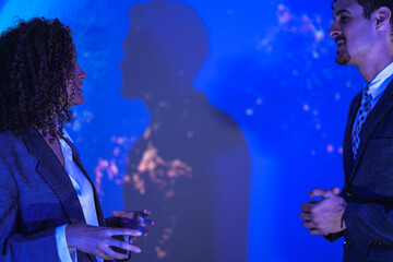 Corporate security experts discussing digital safety strategy. Business partners analyzing network protection and privacy lock concept in modern blue tech office.