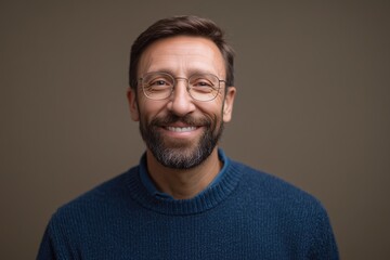 Mature man with a warm smile and blue eyes, looking directly at the camera