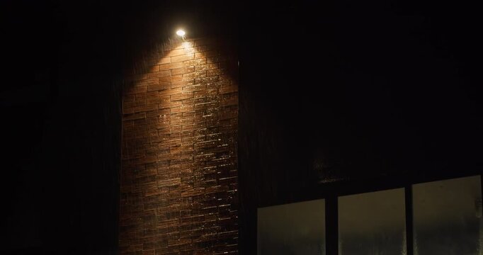 Heavy rain at night with intense rainfall visible in lighting. Severe night time weather conditions