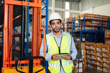 Professional warehouse workers using digital tablet with forklift and pallets. Logistics team management, inventory control, and industrial supply chain concept.