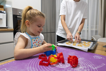 Family culinary traditions mother and daughter cooking biscuits together