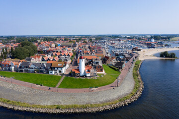 Drone photo of Urk village with the beautiful colorful lighthouse at the harbour by the lake ijsselmeer Netherlands Flevoland Europe
