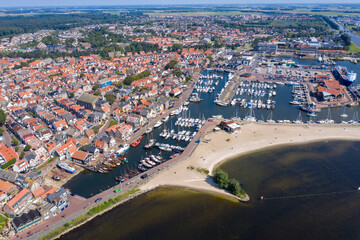 Drone photo of the former Zuiderzee island of Urk with beach harbors and old houses on a beautiful sunny day with cloudless sky