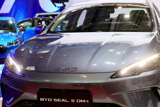Lateral view with logo detail of a BYD Seal 5 DMI, plug-in hybrid, PHEV car. Automotive industry. Photographed in ambiental light. Romania, Bucharest, October 2025.
