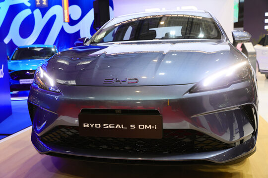 Lateral view with logo detail of a BYD Seal 5 DMI, plug-in hybrid, PHEV car. Automotive industry. Photographed in ambiental light. Romania, Bucharest, October 2025.
