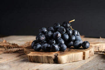 Fresh Dark Grapes on Wooden Board With Rustic Background Setting