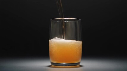 Slow motion drink pour video, transparent liquid flowing into glass, soft highlights, minimal dark background