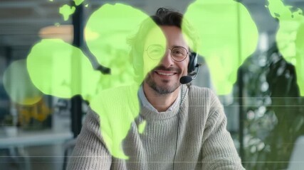 Cheerful professional male wearing headset, glasses participates in online meeting from stylish workspace. Highlights remote work, digital collaboration, modern office culture