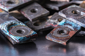 Nonferrous metal plates and patinated copper busbars with visible oxidation show aging and corrosion, symbolizing rare earth elements and price-demand shifts in metallurgical and power markets.