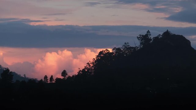 Sunrise in the mountains of Sri Lanka, view of bright cloud against the backdrop of the small Adama peak