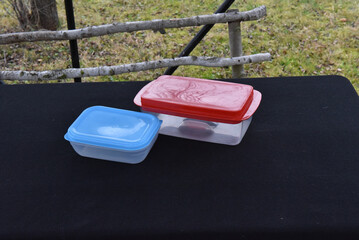 Stackable rectangular plastic food storage containers with colored lids for kitchen organization and meal prep