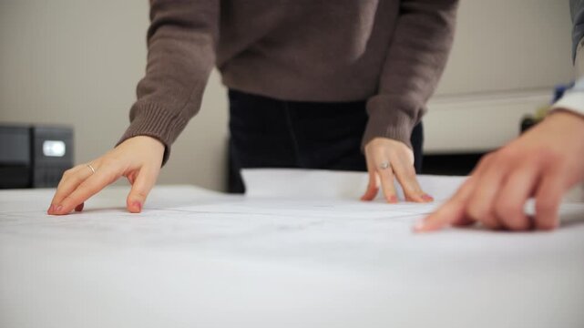 Architects reviewing construction drawings on desk