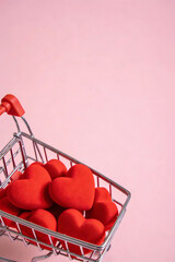 Shopping Cart Filled with Red Hearts on Pink Background, Valentine Concept