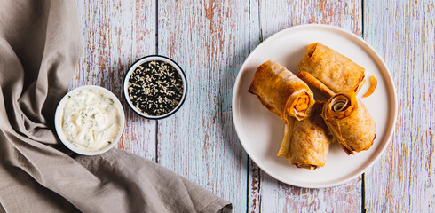 Tortilla, ham and cheese in baked rolls on a plate on the table top view web banner