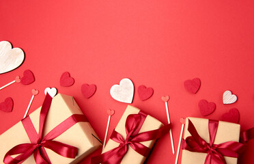 Beautiful and romantic valentines background with present and hearts in red for valentines day or anniversary holiday celebration with copy space