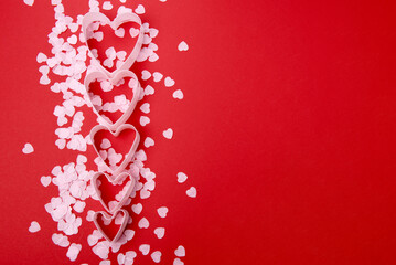 Beautiful and romantic valentines background with present and hearts in red for valentines day or anniversary holiday celebration with copy space