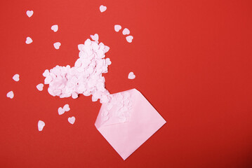 Beautiful and romantic valentines background with present and hearts in red for valentines day or anniversary holiday celebration with copy space