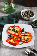 Fried bell pepper rings with sausages, tomatoes and egg on a plate on the table vertical view