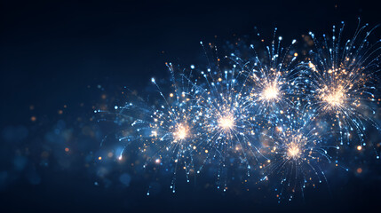 Vibrant fireworks exploding in dark night sky with sparkling blue and gold lights