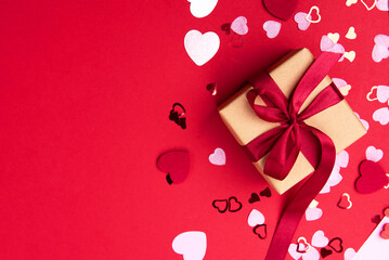 Beautiful and romantic valentines background with present and hearts in red for valentines day or anniversary holiday celebration with copy space