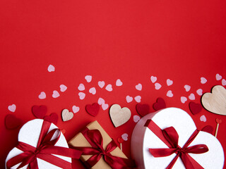 Beautiful and romantic valentines background with present and hearts in red for valentines day or anniversary holiday celebration with copy space