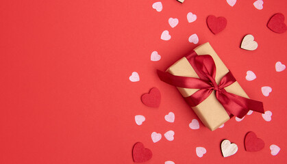 Beautiful and romantic valentines background with present and hearts in red for valentines day or anniversary holiday celebration with copy space