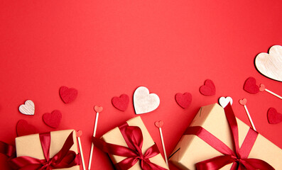 Beautiful and romantic valentines background with present and hearts in red for valentines day or anniversary holiday celebration with copy space