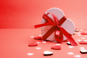 Beautiful and romantic valentines background with present and hearts in red for valentines day or anniversary holiday celebration with copy space