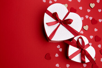 Beautiful and romantic valentines background with present and hearts in red for valentines day or anniversary holiday celebration with copy space