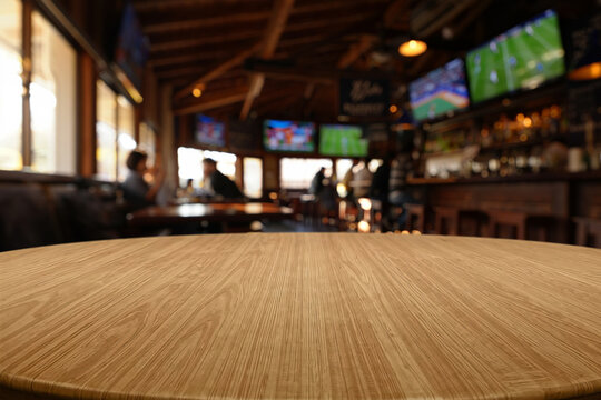 Sports bar interior with large screens and countertop in the foreground