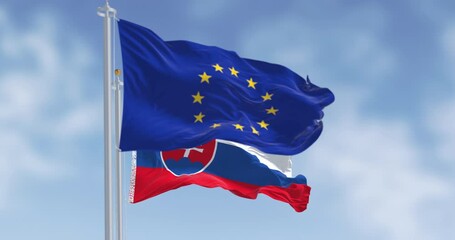 Close-up of Slovakia and the European Union flags waving on a clear day