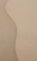 warm photograph textured curved sand surface shades beige taupe shot directly shallow depth