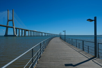 Fototapeta premium Vasco da Gama Bridge and Riverside Walkway at Parque das Nações in Lisbon