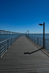 Fototapeta premium Vasco da Gama Bridge and Riverside Walkway at Parque das Nações in Lisbon
