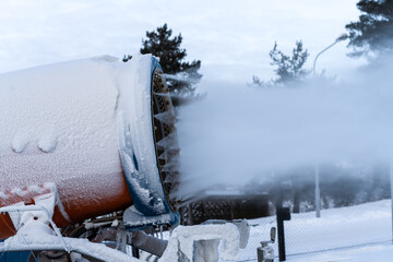 Snow cannon. A snow making machine on the ski slope to prepare the ski resort for the next day. The winter sports industry.