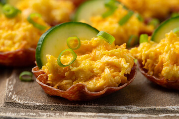 Crispy salami cups with cheese filling, antipasto, snack, party food