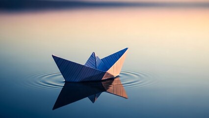 Obraz premium Origami boat floating on calm water.