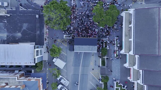 Drone lowers in bird's eye view  during evening block party in Plettenberg Bay, South Africa