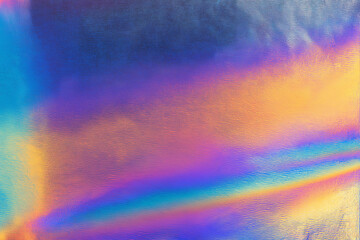 Iridescent surface with rainbow reflections. Suitable for backgrounds, textures, or design elements needing colorful, dynamic light effects.