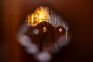 Sunlight filters through stained glass, illuminating the sacred space