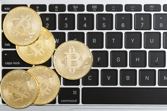 Group of Bitcoin on laptop keyboard background, Cryptocurrency trading technology concept. Crypto is digital money within the blockchain network