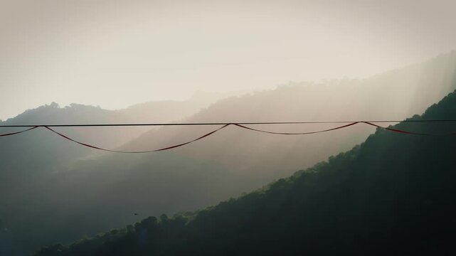 Morning mist and golden rays frame every careful step along the line