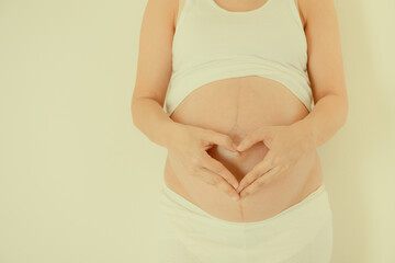 Big belly of pregnant woman isolated on white background