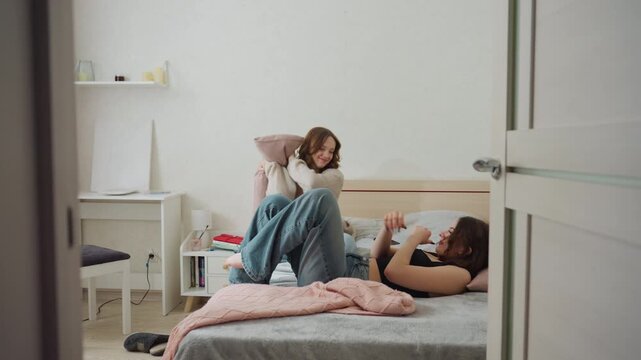Friendly Play During Bedtime, Laughter And Roughhousing In Cozy Bedroom Setting, Joyful Companionship Captured As Friends Share Laughter And Playful Struggles In Warm Bedroom Environment