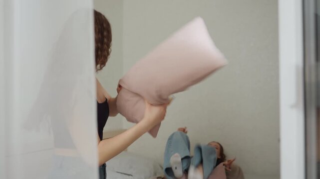 Joyful Laughter Exchange, Room Filled With Cheerful Women Engaging In Lively Pillow Battles Indoors, Group Of Young Women Enjoying Spirited And Cheerful Indoor Pillow Fighting Activity Collectively