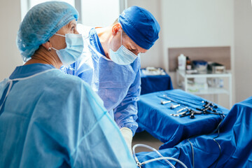 Surgeons performing gynecological operation in sterile hospital operating room