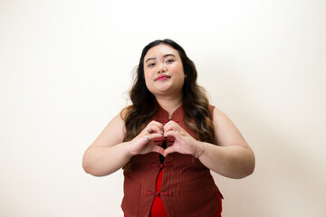 Woman Making Heart Shape, Indoor Setting, Lifestyle Photography, Uplifting Atmosphere, Close-Up View