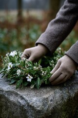 Fototapeta premium Hands arranging flower wreath on stone surface in outdoor setting